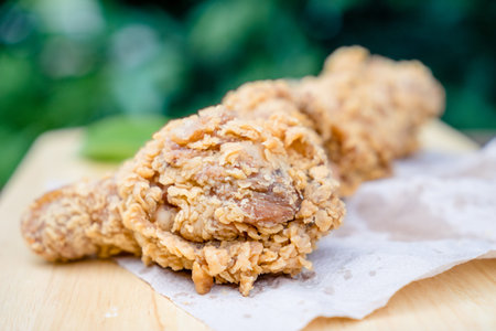 Fried chicken leg on wooden table
