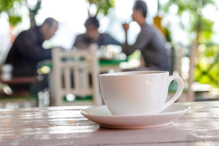 white coffee cup on pink wooden tableの写真素材