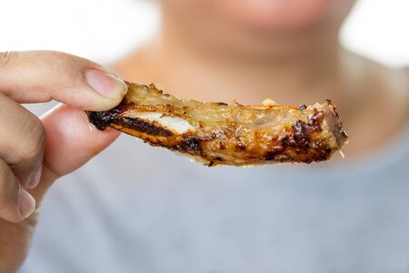 hand of woman holding fried pork for eatの写真素材