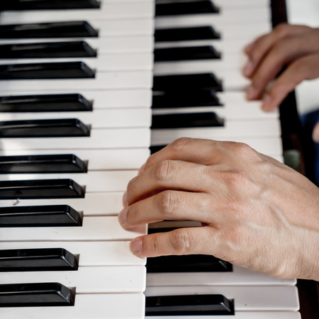 man hand playing pianoの写真素材