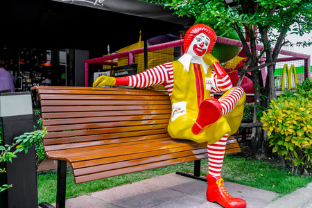 BANGKOK, THAILAND -january 31: Ronald McDonald character sitting on bench, in front of McDonalds restaurant at Thailand on january 31 2015のeditorial素材