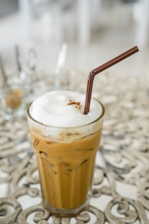 close up ice coffee with milk on  tableの写真素材