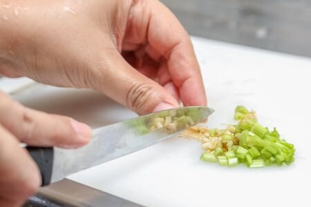 Chef chopping parsley for cookingの写真素材