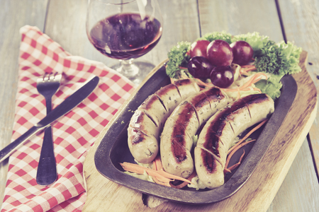 German sausages with wine on wooden tableの写真素材