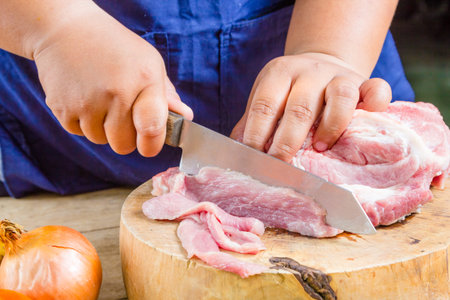 sliced pork on cutting bord for cooking