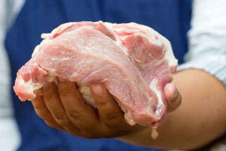 hand holding fresh porkの写真素材