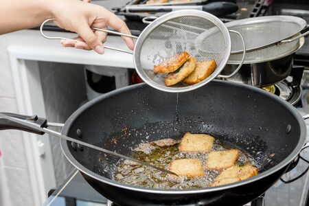 bread with raw minced pork spread frying in panの写真素材