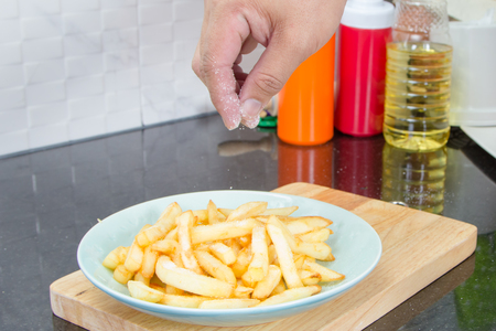 french fries in metal basket on plateの写真素材