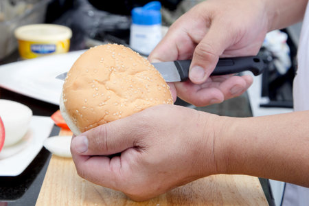 chef cutting bun making for american cheese burgerの写真素材