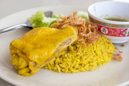 yellow chicken rice with vegetablesの写真素材