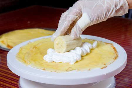 chef make chocolate banana crepe and whipped creamの写真素材