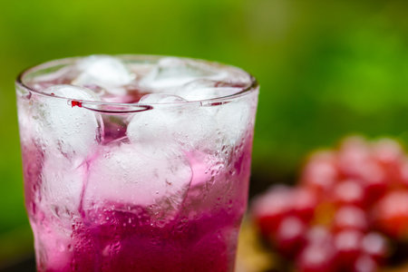 Red grape fruits and grape juice on wooden