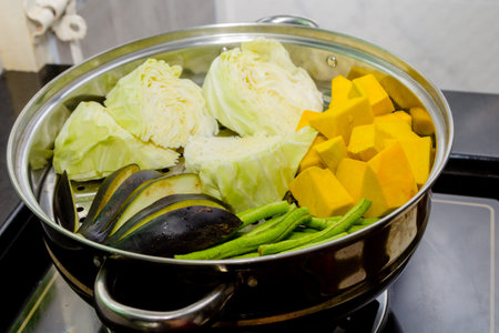 Pumpkin, cabbage, beans, eggplant in steaming potの写真素材
