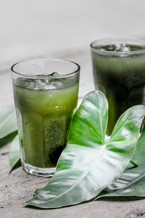 Glass of vegetable juice on woodenの写真素材