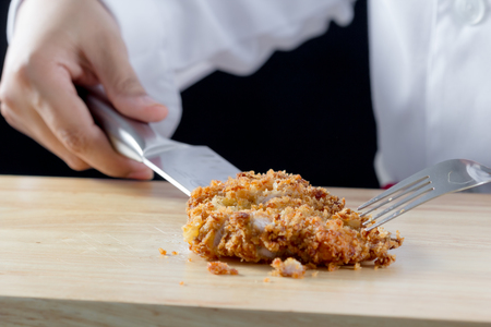 chef cutting Japanese fried pork in kitchenの写真素材