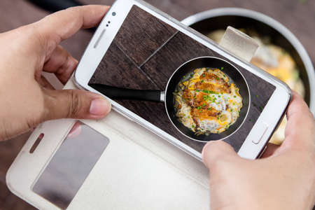 Women taking a photo of japan food name is Katsudonの写真素材