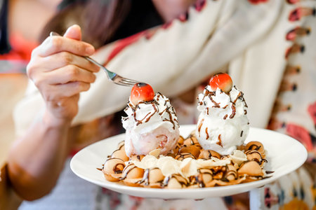 women holding waffles with chocolate sauce, ice cream and whipping cream