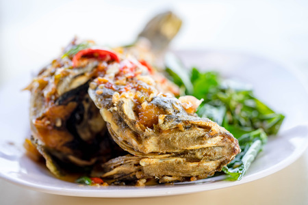 deep fried fish with spicy sauceの写真素材