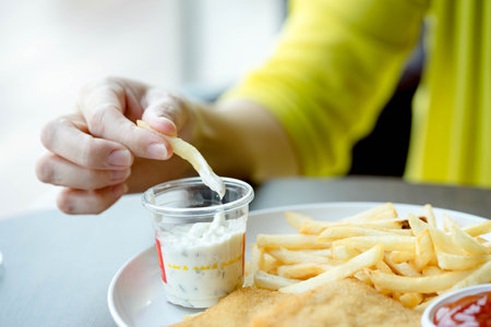 women eating french fries on fast food restaurantの写真素材