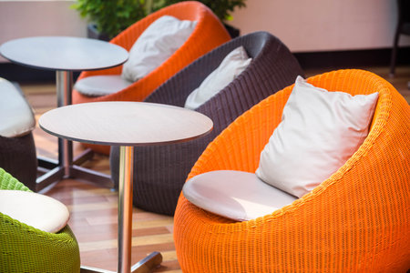 colourful outdoor wicker chairs with cushionsの写真素材