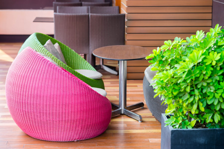 colourful outdoor wicker chairs with cushionsの写真素材