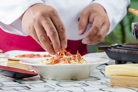 chef making spaghetti  carbonara with baconの写真素材