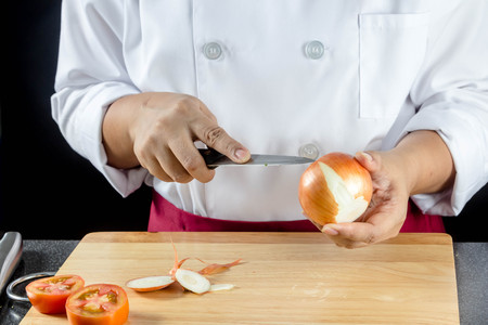 chef chopped onions on wooden boardの写真素材