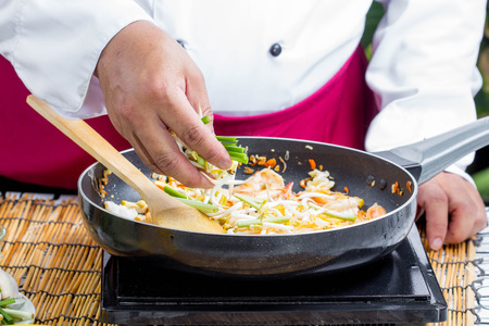 chef cook preparing Thai Fried Noodles Pad Thai with shrimpの写真素材