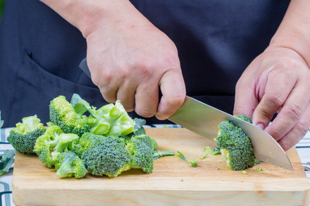 chef sliced broccoli on wooden boardの写真素材