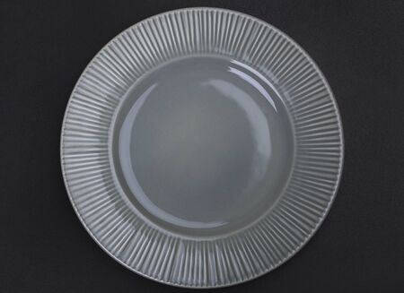 Green Plate top view on black backgroundの写真素材