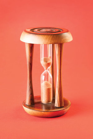 The old hourglass on a red background