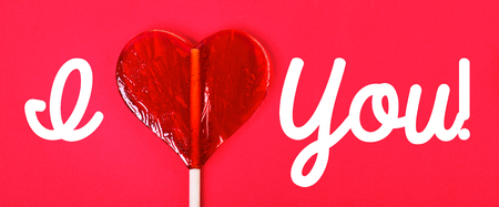 One candy heart shape on pink background and inspiration Â«I Love You!Â»の写真素材