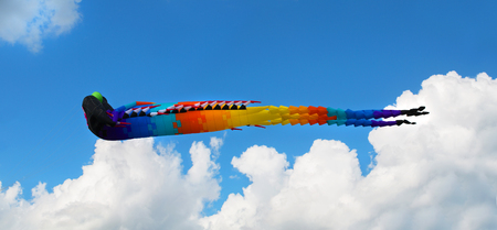 Big Chinese dragon kite in the blue sky and cloudsの写真素材