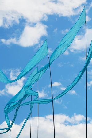 Blue flags are singing in the wind against the blue sky