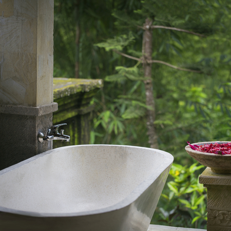 Marble stone spa bathroom in a villa surrounded by rainforestの写真素材