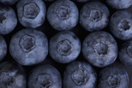 A bunch of blueberries macro shot on a black backgroundの写真素材