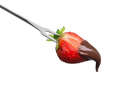Fondue half of a ripe strawberry in hot chocolate isolated on white backgroundの写真素材