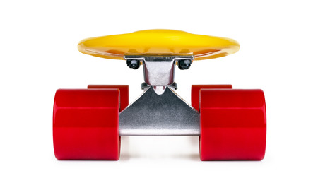 Yellow cruiser penny plastboard with red wheels isolated on white background, front viewの写真素材