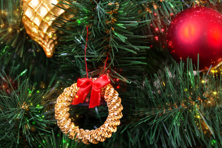 Gold, red and straw vintage decorations in the Scandinavian style on an artificial Christmas tree, close-upの写真素材