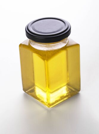 Mockup glass jar of fresh flower honey Isolated on a white backgroundの写真素材