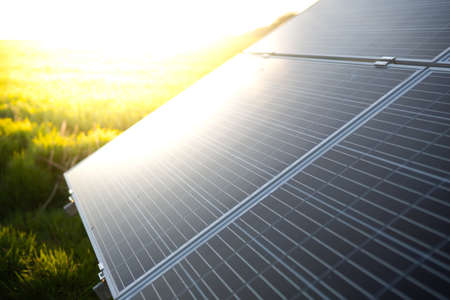 Photovoltaic modules for renewable energy. Solar panels with sun background. Green clean alternative power energy.の写真素材