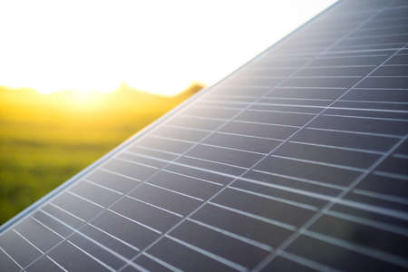 Photovoltaic modules for renewable energy. Solar panels with sun background. Green clean alternative power energy.の写真素材