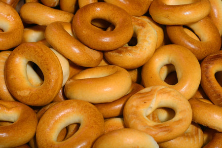 Closeup of a heap of tasty golden bagels.の写真素材