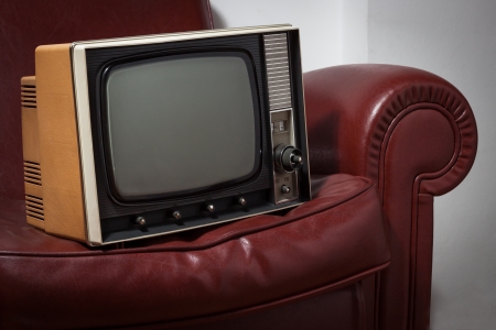 vintage television on a red leather couchの写真素材
