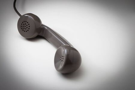 Vintage telephone receiver isolated on a white surfaceの写真素材