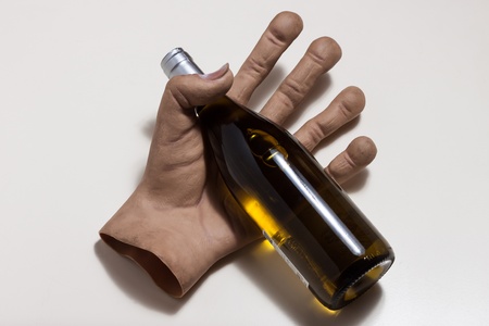 Top view of huge hand holding a bottle of white wineの写真素材
