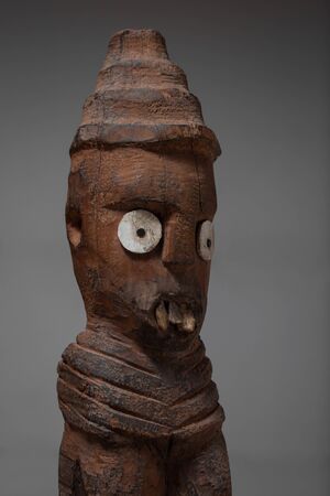 Antique african wooden statue against dark backgroundの写真素材