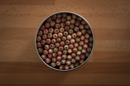 Top view of a box with crayons on wooden surfaceの写真素材