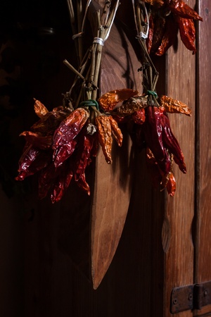 Bunch of dry red peppers against a wooden backgroundの写真素材
