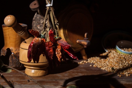 Still life of a bunch of dry red pepper with some culinary items on the backgroundの写真素材